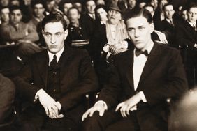 Leopold and Loeb on Trial in Joliet. Chicago: This photograph shows right to left, Richard Loeb and Nathan Leopold Jr., millionaire "lifers" defending themselves against a $100,00 damage suit brought by a Chicago taxicab driver, who charges they mutilated him on November 21, 1923. The case is being heard at Joliet, Illinois. Charles Ream, the plaintiff is at right with hands crossed.