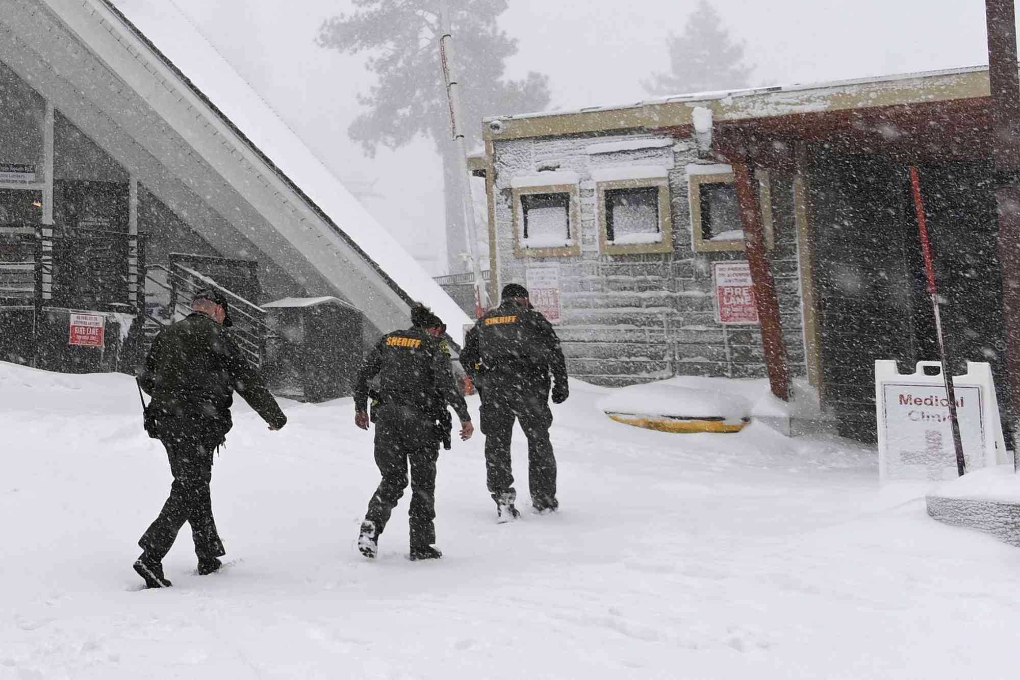 Placer County sheriffs walk toward the medical clinic at Palisades Tahoe on Wednesday, Jan. 10, 2024, in Tahoe, Calif