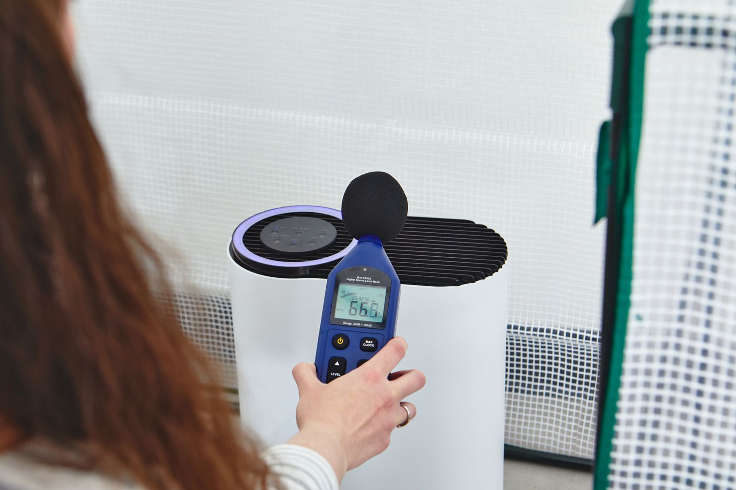 person testing the noise level of the Aroeve MK04 Air Purifier