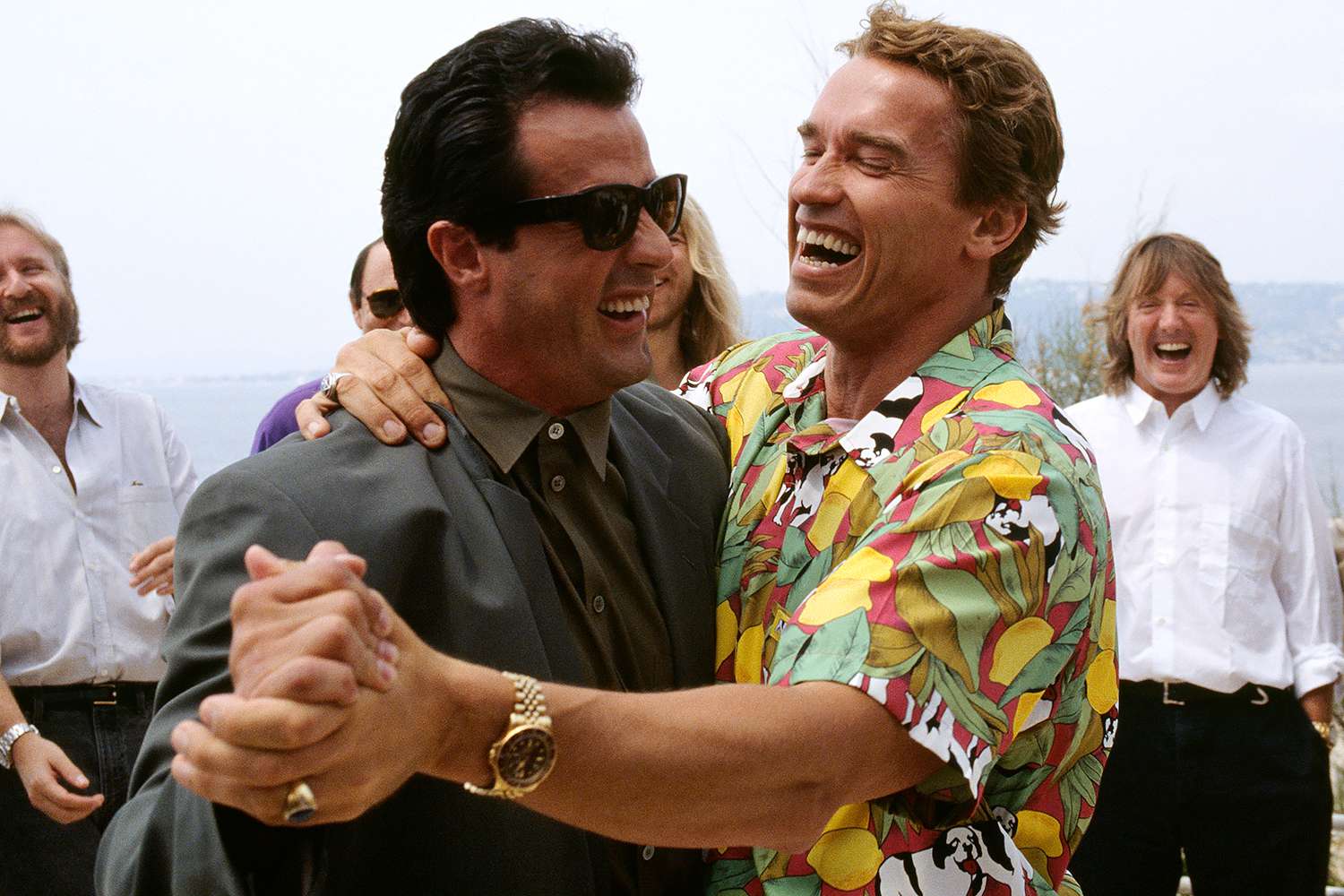 American actor Sylvester Stallone and Austrian born actor, Arnold Schwarzenegger dancing for a joke, during the 43th International Cannes Film Festival. 