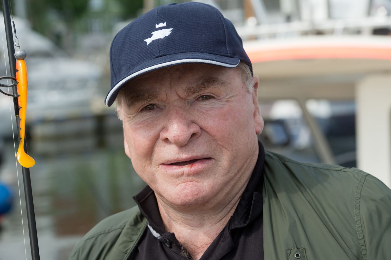 ctor Fritz Wepper sits with a fishing rod on a fishing boat in Stralsund harbour