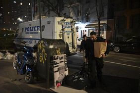 Investigators are examining evidence bags at the crime scene in Manhattan, New York, on March 15, 2024.