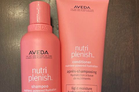 Bottles of Aveda Nutriplenish Light Moisture Shampoo and Conditioner
