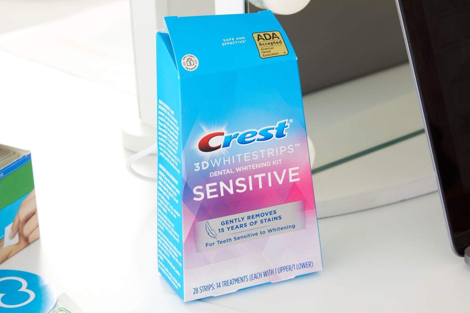 Crest 3D Whitestrips Sensitive Teeth Whitening Kit placed on table
