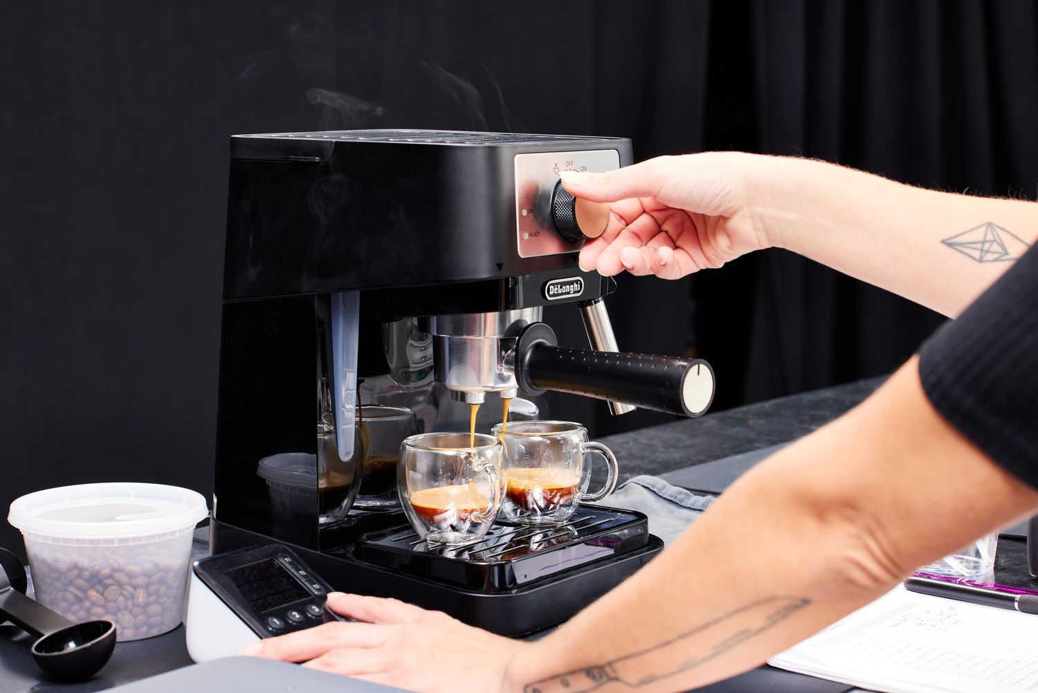 A person brewing two shots of espresso using the De'Longhi Stilosa Espresso Machine.