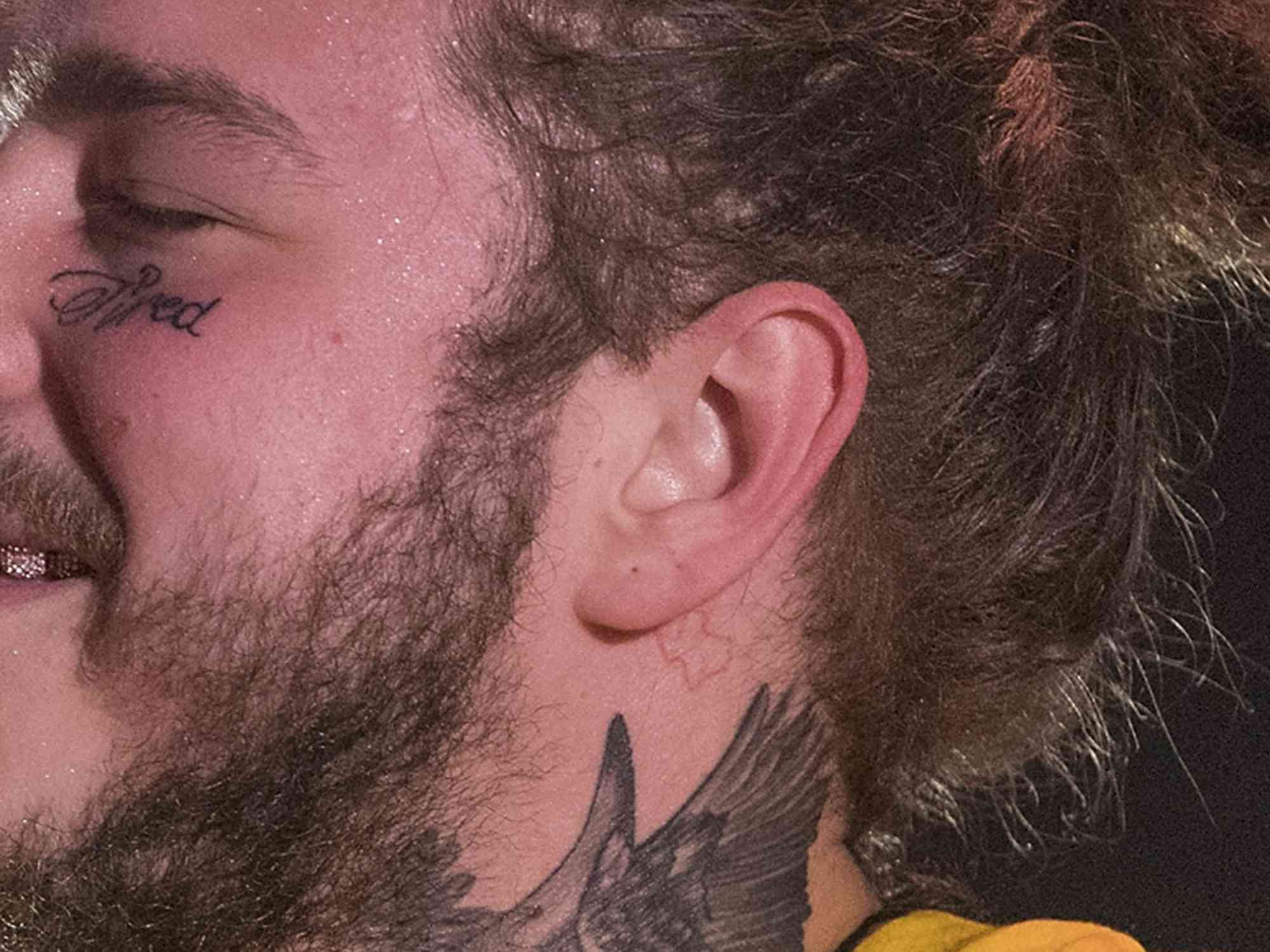 Post Malone (tattoo detail) performs in concert at Austin360 Amphitheater on June 16, 2018 in Austin, Texas. (Photo by Rick Kern/WireImage)