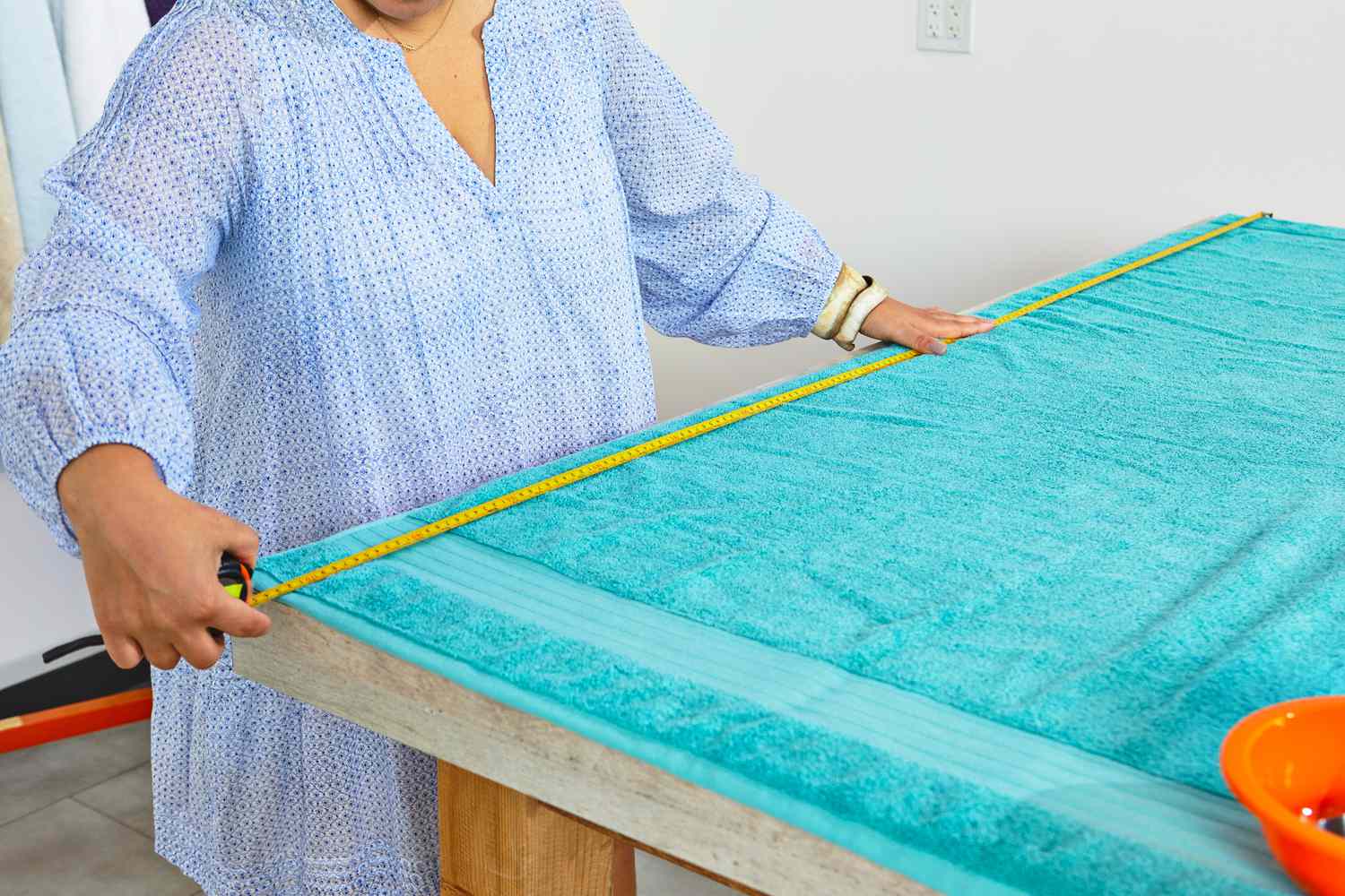 A person measuring the Hammam Linen Jumbo Large Bath Sheets