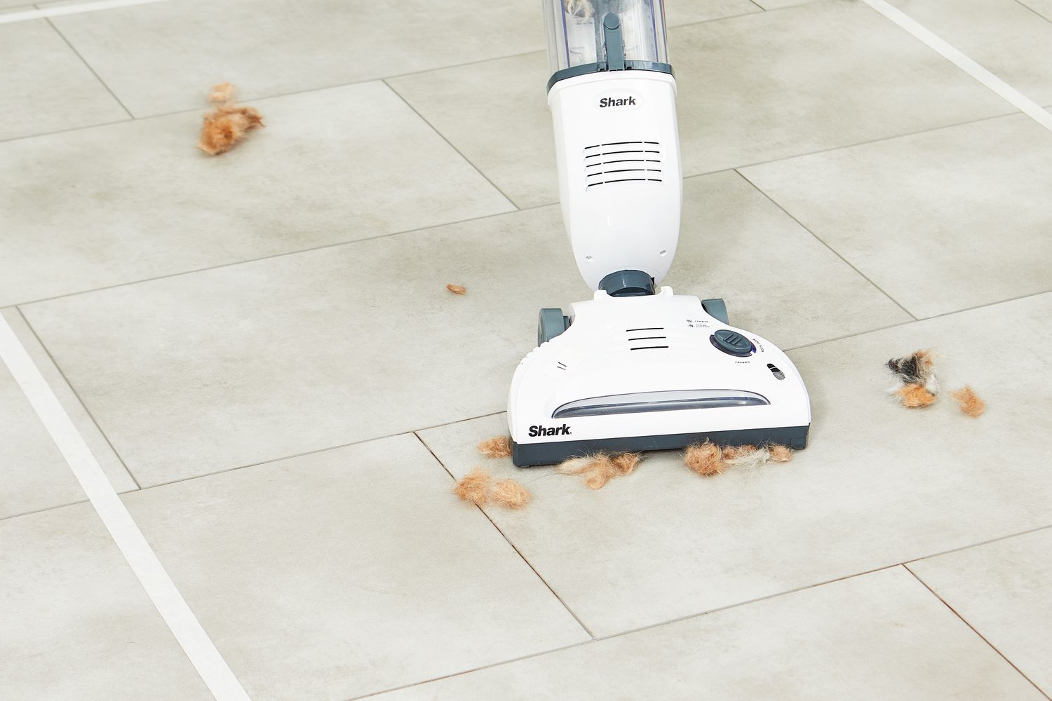 Shark Navigator Freestyle Cordless Upright Vacuum being used to remove hair from floor