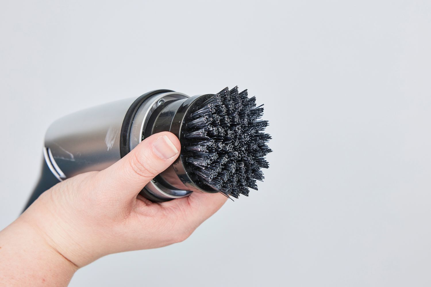 Close-up of a hand holding the head of a HattyRoom Rechargeable Cordless Electric Spin Scrubber