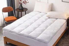 The Drovan Extra Thick Mattress Topper on a bed in a bedroom