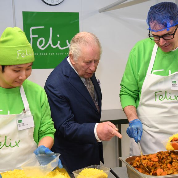 King Charles III talks to staff during his visit to the Felix Project on February 22, 2023 in London, England. The Felix Project provides meals for vulnerable people in London.