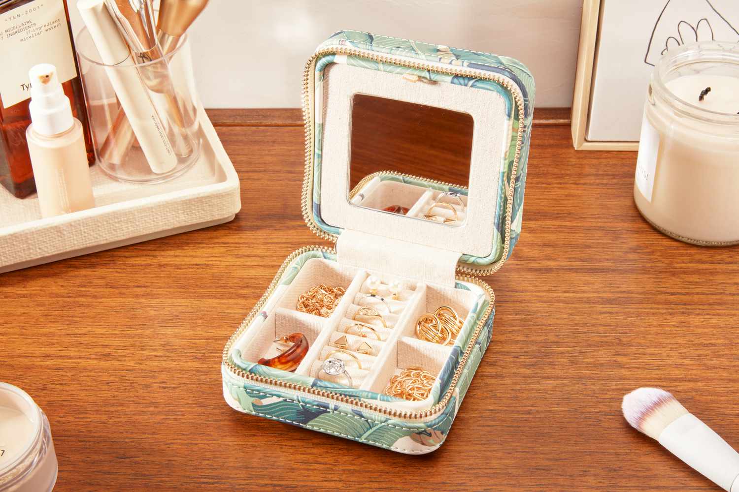 A Mark & Graham Small Travel Jewelry Case open on a counter