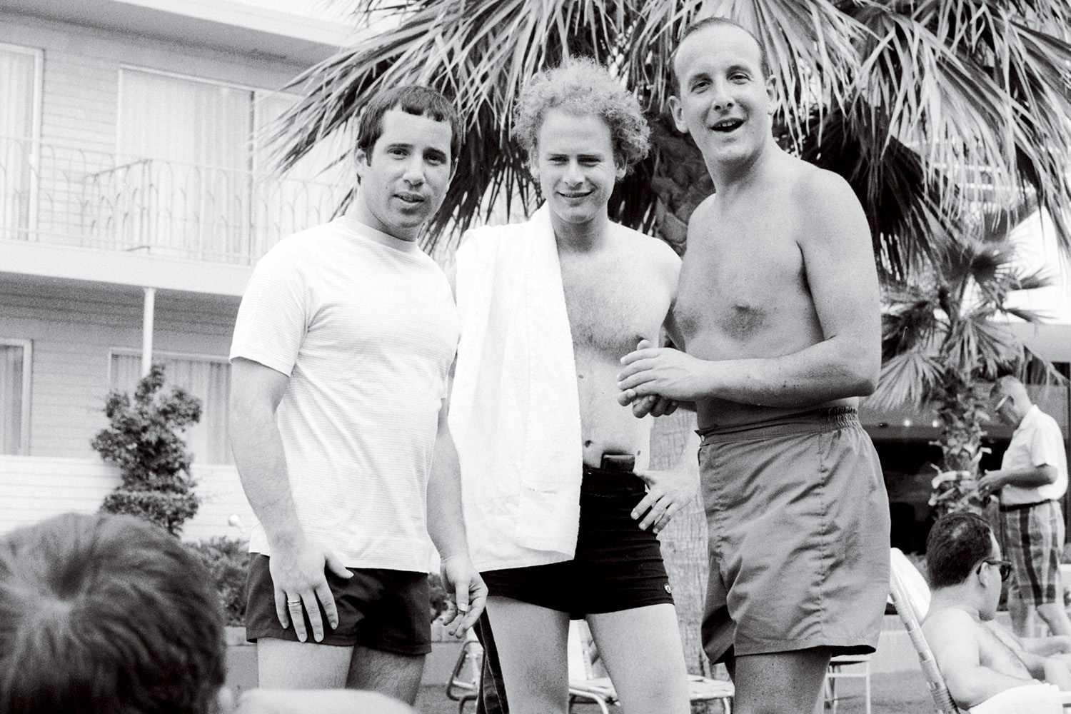 Paul Simon, Art Garfunkel, and Clive Davis Caption reads Three boys from the outer boroughs by the pool at the Columbia Records convention, 1970