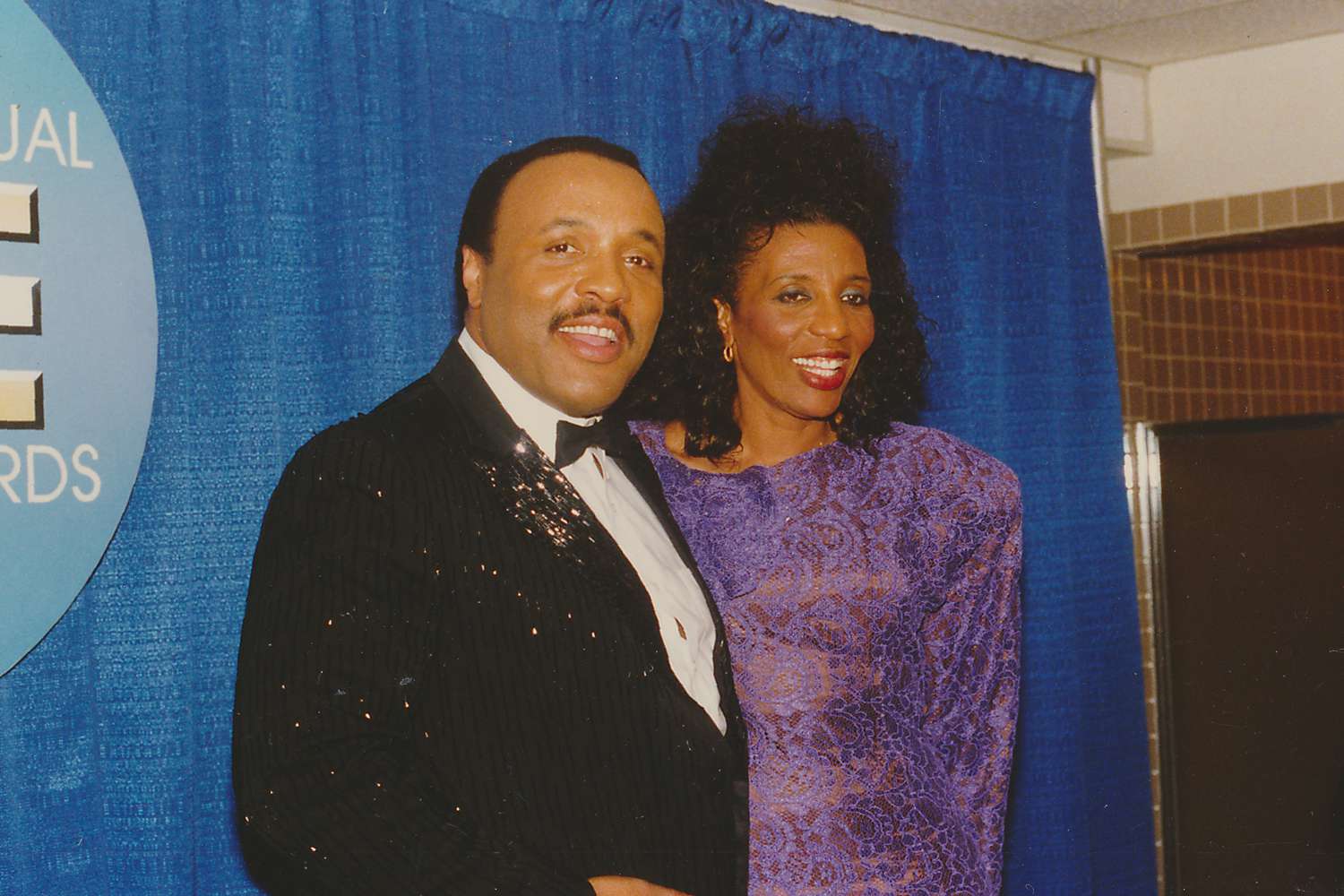 Mid shot of smiling American gospel singers and twins, Andrae and Sandra Crouch, posing backstage after accompanying singer Jennifer Holiday during an annual award ceremony, photographed by Clarence Gatson, San Francisco, California, 1985. 