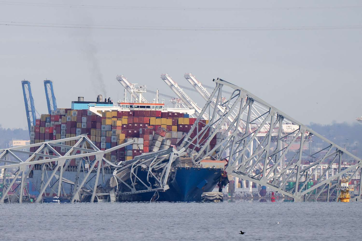 A container ship rests against wreckage of the Francis Scott Key Bridge on Tuesday, March 26, 2024, as seen from Pasadena, Md. The ship rammed into the major bridge in Baltimore early Tuesday, causing it to collapse in a matter of seconds and creating a terrifying scene as several vehicles plunged into the chilly river below. 