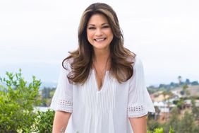 Host Valerie Bertinelli poses for a photo at the dinner table, as seen on Food Network's Valerie's Home Cooking, Season 3.