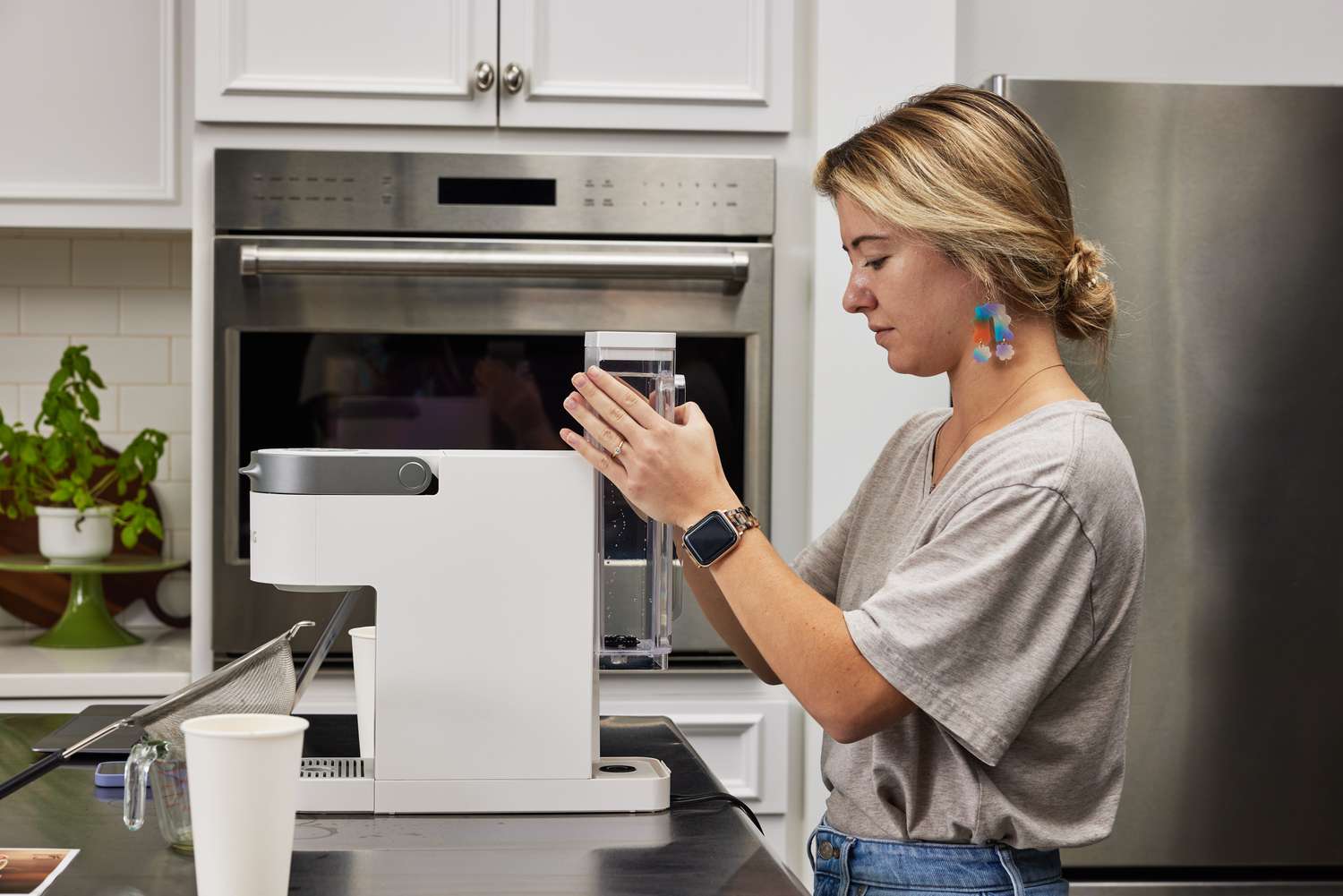 Person inserting water into the Keurig K-Slim Single Serve Coffee Maker