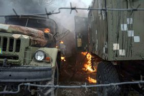 Ukrainian military track burns at an air defence base in the aftermath of an apparent Russian strike in Mariupol, Ukraine