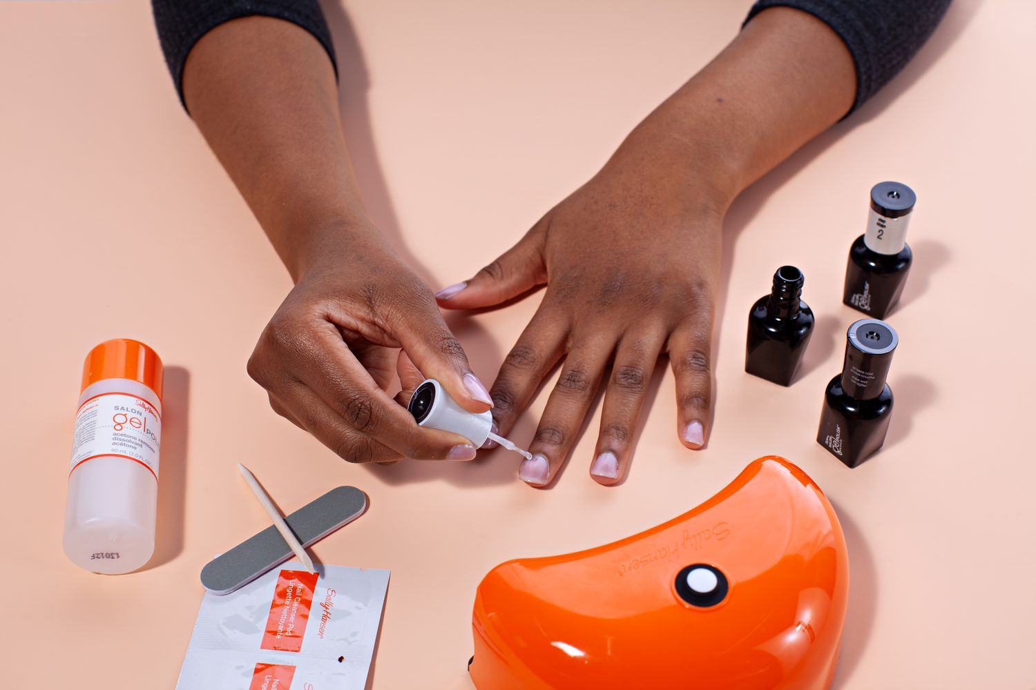 Hands using polish from Sally Hansen Salon Pro Gel Starter Kit