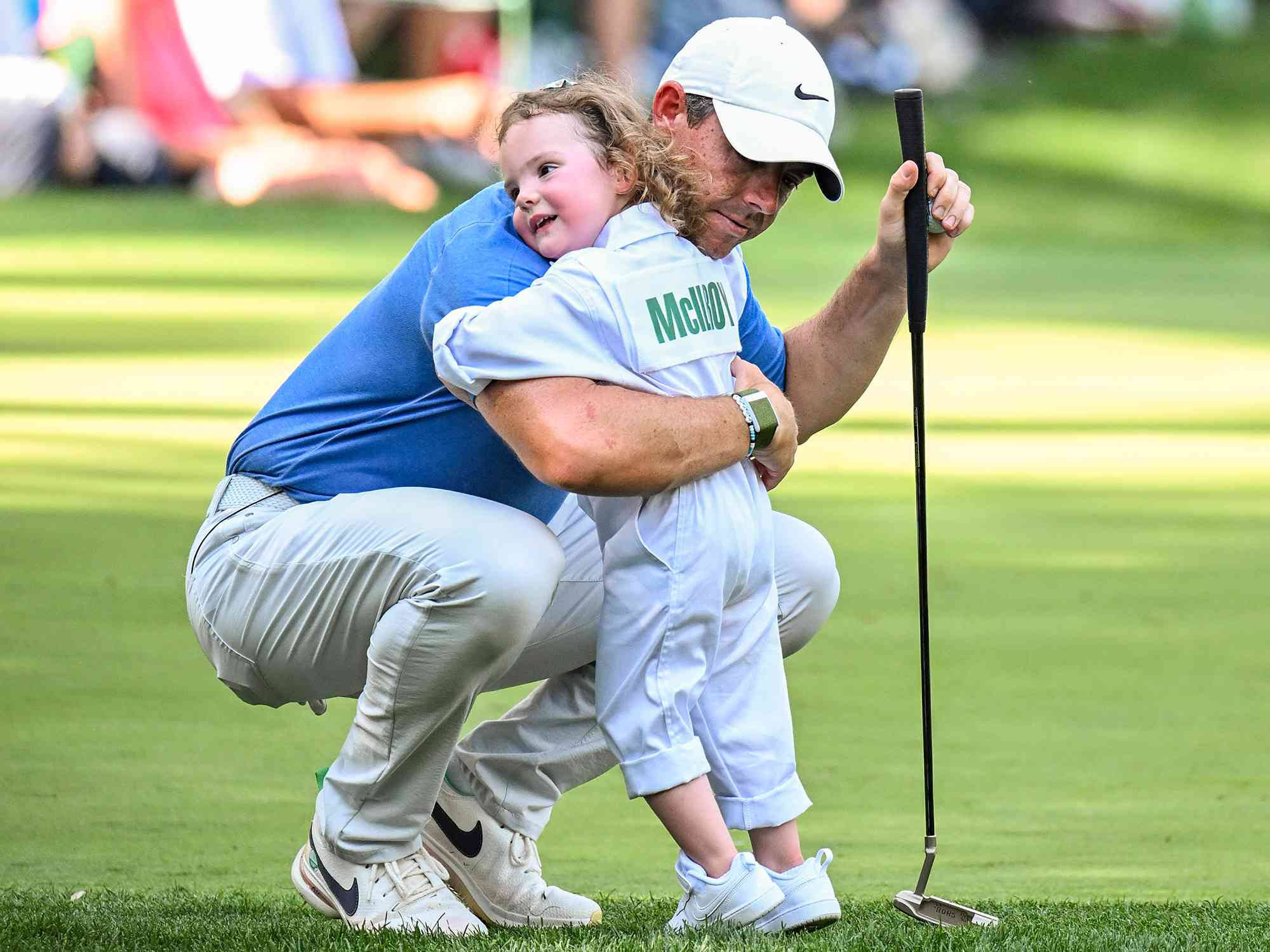 Rory McIlroy of Northern Ireland hugs his daughter Poppy on the ninth hole during the Par 3 Contest prior to the 2023 Masters Tournament at Augusta National Golf Club 