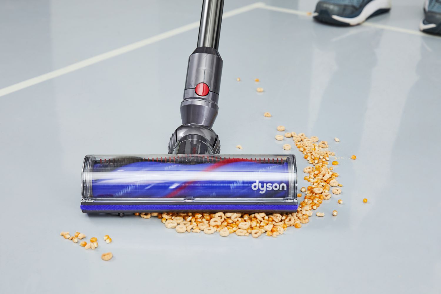 Dyson V12 Detect Slim cleaning cheerios and popcorn kettles off the floor