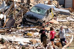 People survey debris from tornado damaged homes in Greenfield,Iowa.