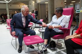 King Charles III speaks with patients during a visit to the University College Hospital Macmillan Cancer Centre in London