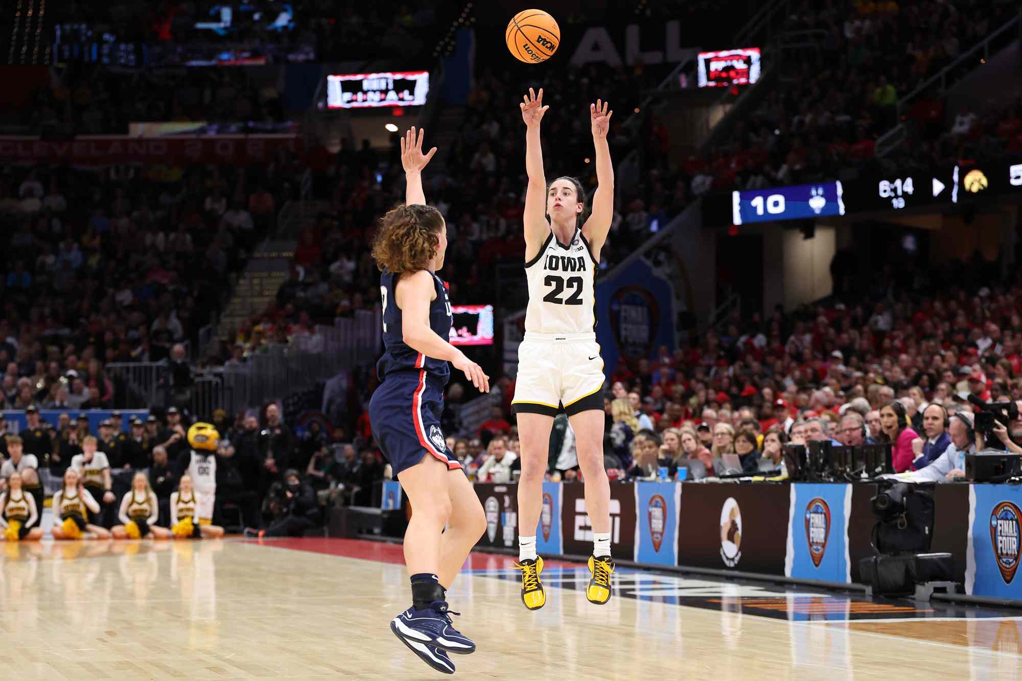 Caitlin Clark #22 of the Iowa Hawkeyes shoots the ball over Ashlynn Shade #12 of the UConn Huskies in the first half during the NCAA Women's Basketball Tournament Final Four semifinal game at Rocket Mortgage Fieldhouse on April 05, 2024