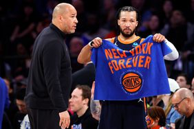 Jalen Brunson #11 of the New York Knicks talks with his father and New York Knicks assistant coach Rick Brunson during the game against the Philadelphia 76ers in Game Two of the Eastern Conference First Round Playoffs at Madison Square Garden on April 22, 2024 in New York City. 
