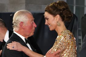 Britain's Prince Charles, Prince of Wales (L) kisses Britain's Catherine, Duchess of Cambridge as they arrive for the World Premiere of the James Bond 007 film "No Time to Die" at the Royal Albert Hall in west London on September 28, 2021.