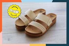 A pair of Reef Cushion Vista Hi Sandals we recommend on a wood floor with a colorful border