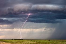 Thunderstorm lightning strike with dark storm clouds