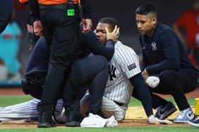 Oscar Gonzalez of New York Yankees is checked by doctors after getting hit in the face by a ball in the second inning during Spring Training Game Two between Diablos Rojos and New York Yankees at Estadio Alfredo Harp Helu on March 25, 2024 in Mexico City, Mexico.