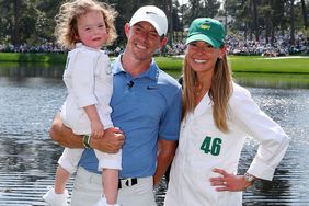 Rory McIlroy of Northern Ireland poses for a photo with his wife, Erica Stoll and daughter Poppy McIlroy during the Par 3 contest prior to the 2023 Masters Tournament at Augusta National Golf Club