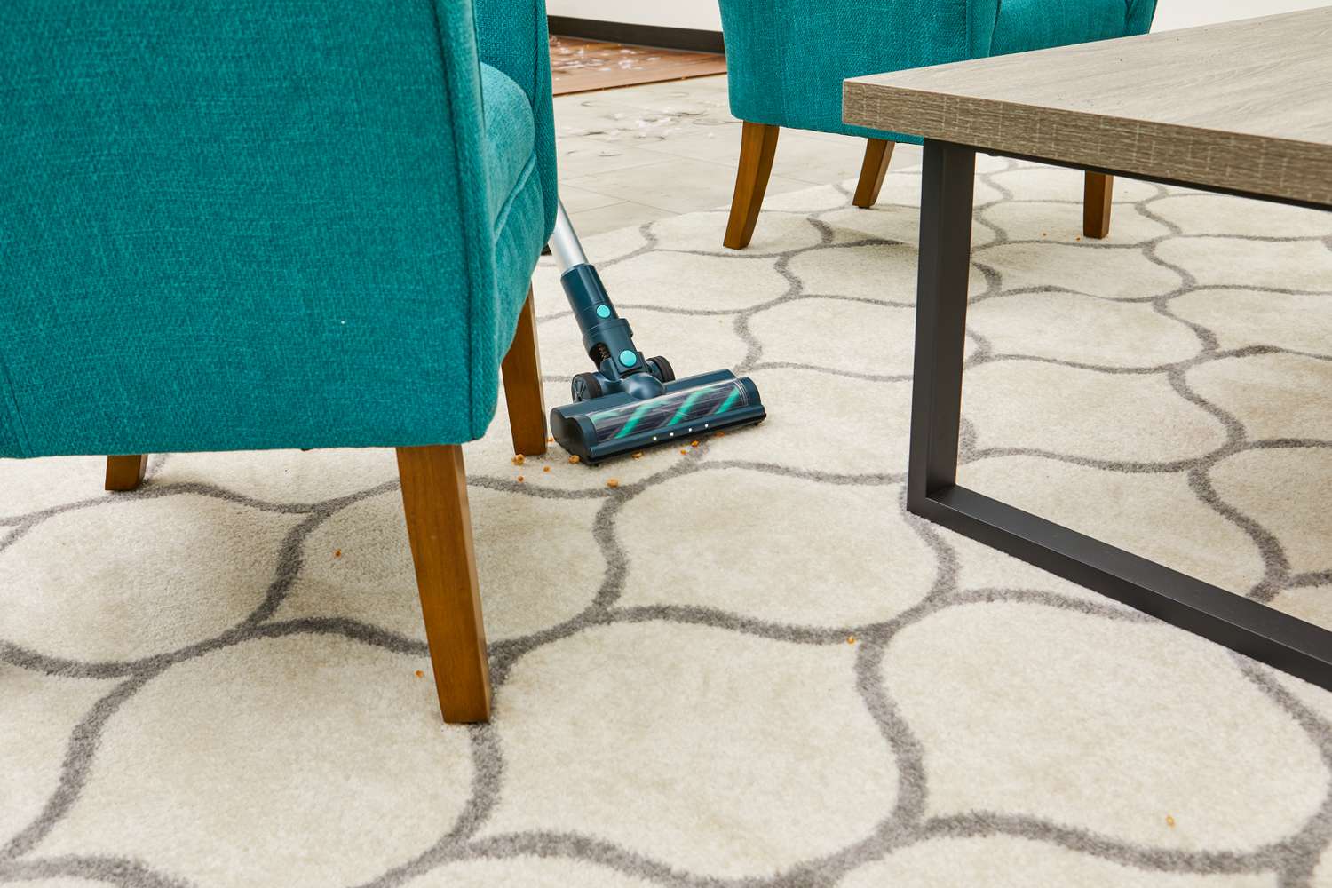 The Belife V12 Cordless Vacuum Cleaner being used to vacuum around the legs of a chair.