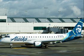 An Alaska Horizon branded airplane is seen on the runway in Portland International Airport