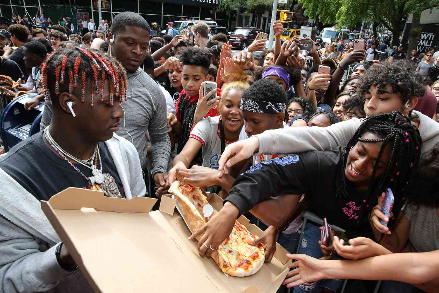 NEW YORK, NY - AUGUST 25: Rapper Lil Yachty gives pizza to a crowd of fans at Yachty's Pizzeria, a pop-up pizzeria at Famous Ben's Pizzeria located on 177 Spring Street on August 25, 2017 in New York City. (Photo by JP Yim/Getty Images)
