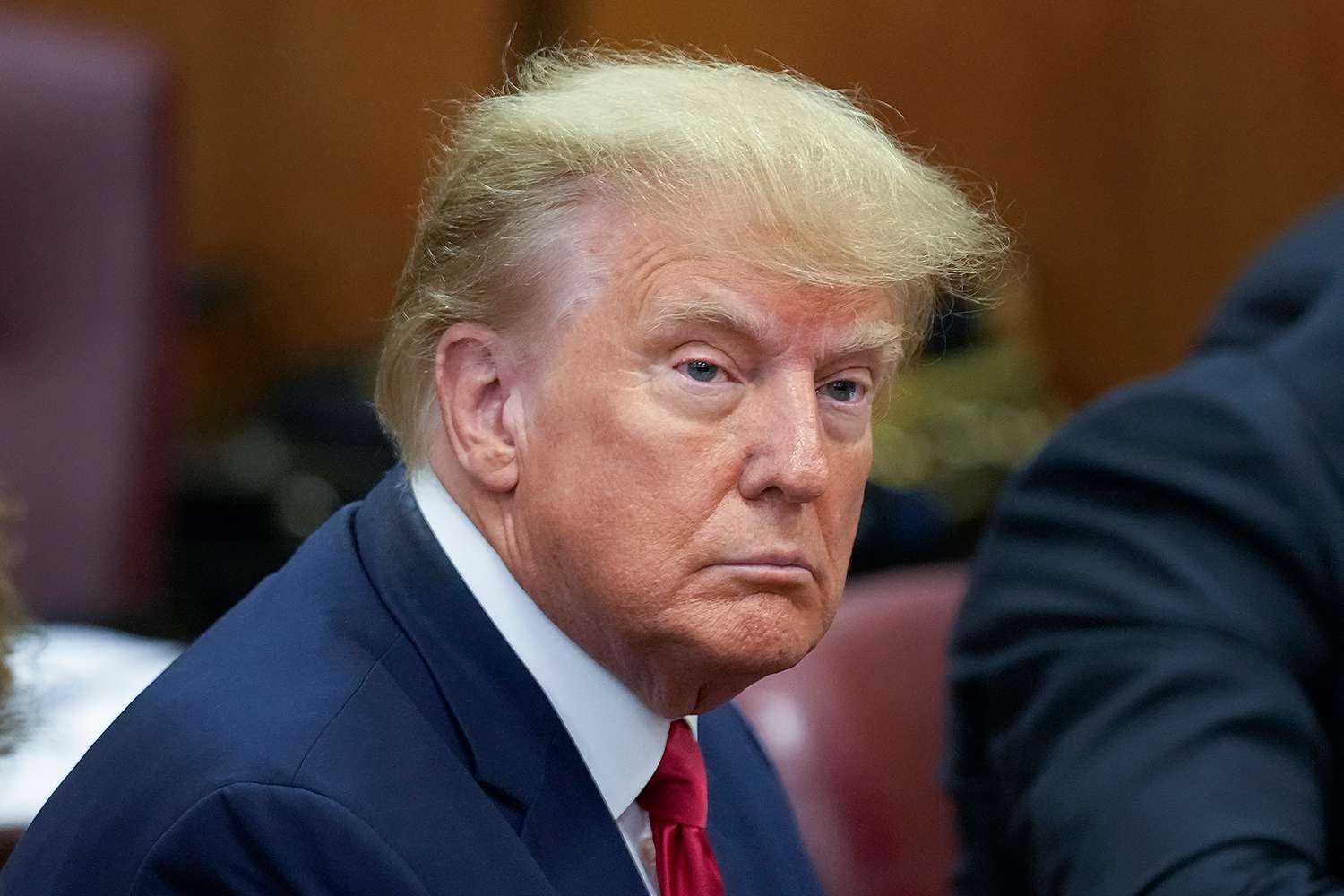 Former U.S. President Donald Trump sits at the defense table with his defense team in a Manhattan court on April 4, 2023 in New York City.