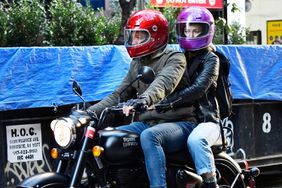Amy Robach and TJ Holmes hit the road on a motorcycle in New York City. The former newscasters were dressed similar in motorcycle jackets, cuffed jeans, and leather boots as they took a spin on TJ's Royal Enfield. The sighting comes after news that Holmes settled divorce with Marilee Fiebig nearly 1 year after his alleged affair.