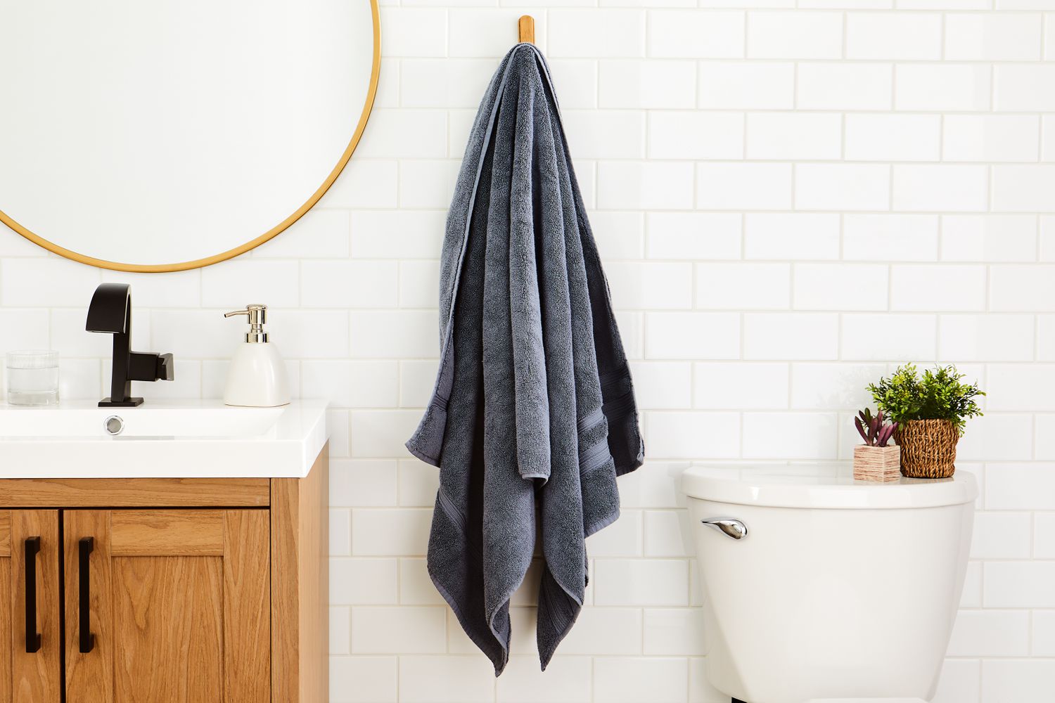 Parachute Classic Turkish Cotton Towel hanging on a hook in a white bathroom