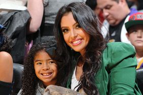 Vanessa Bryant (R) and daughters Natalia (L) and Gianna (C) pose for a photograph during a game between the New York Knicks and the Los Angeles Lakers at Staples Center on December 25, 2012 in Los Angeles, California.