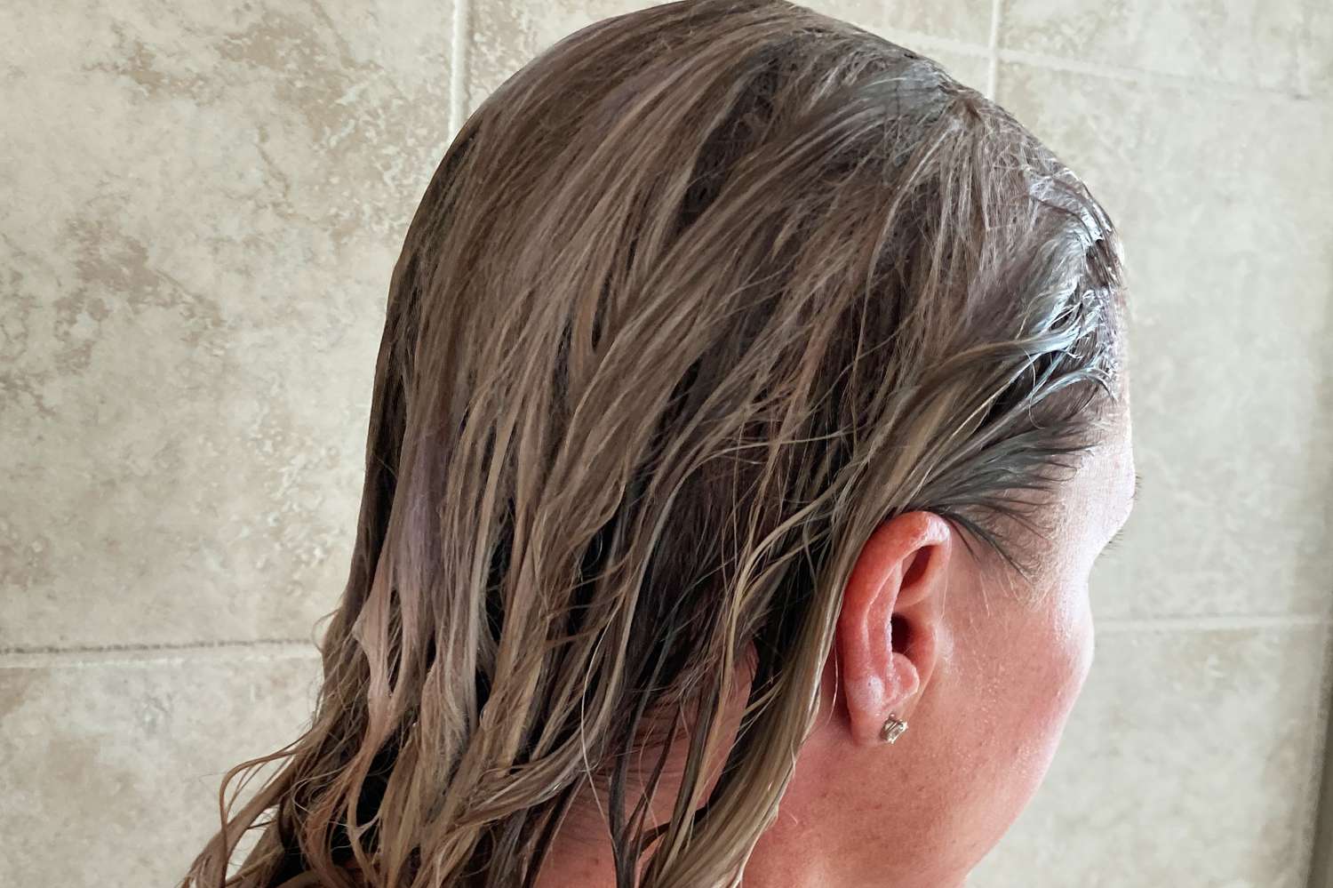 A person applies Saltair Beach Blonde Shampoo