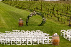 A view over a vineyard sets the scene for a wedding ceremony.