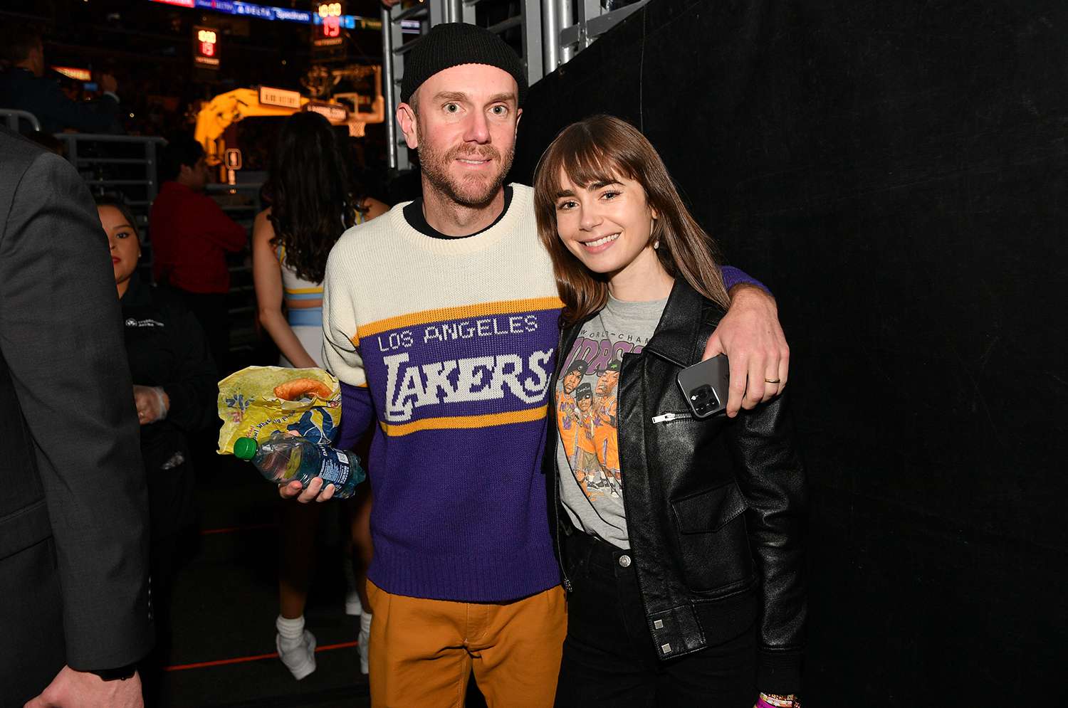 Lily Collins and Charlie McDowell attend a basketball game between the Los Angeles Lakers and the Golden State Warriors