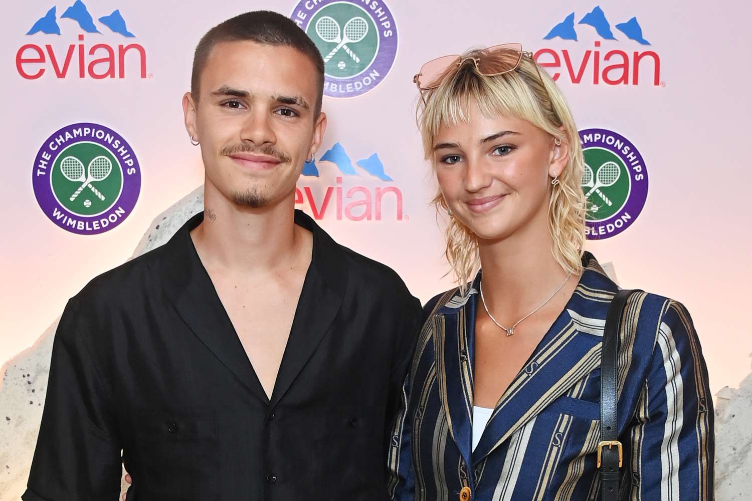 Romeo Beckham and Mia Regan pose in the evian VIP Suite At Wimbledon 2023 on July 11, 2023 