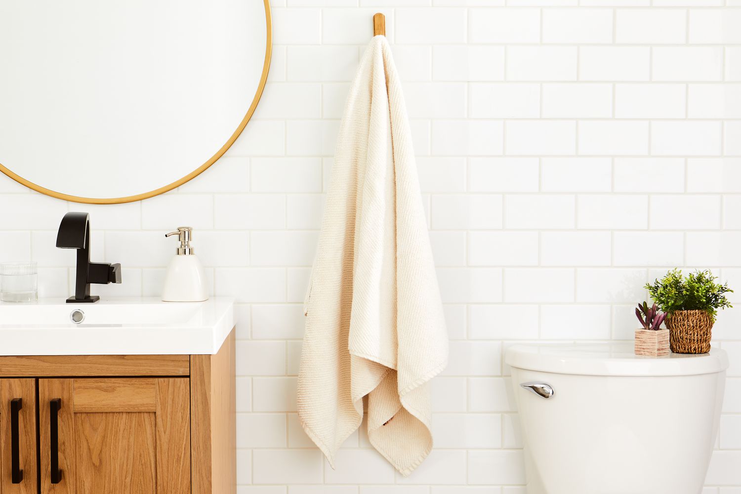 Coyuchi Air Weight Organic Towels hung on hook in bathroom