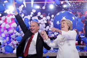 Democratic presidential candidate Hillary Clinton and US Vice President nominee Tim Kaine stand on stage at the end on the fourth day of the Democratic National Convention at the Wells Fargo Center, July 28, 2016 in Philadelphia, Pennsylvania. Democratic presidential candidate Hillary Clinton received the number of votes needed to secure the party's nomination. An estimated 50,000 people are expected in Philadelphia, including hundreds of protesters and members of the media. The four-day Democratic National Convention kicked off July 25.