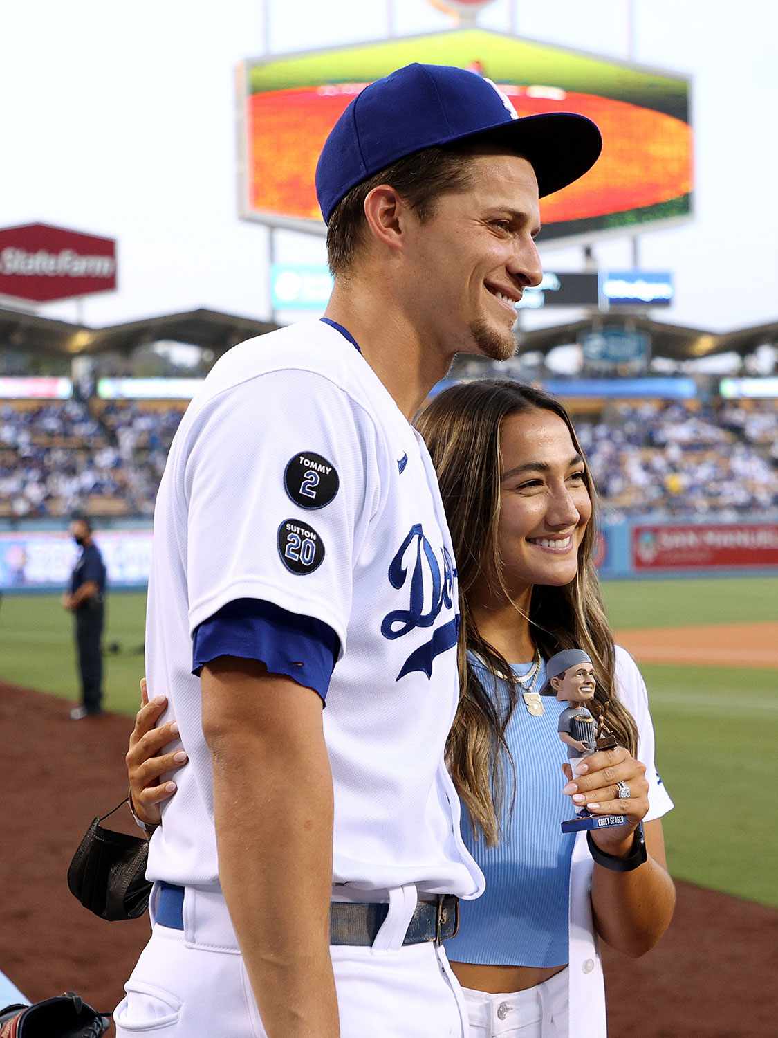  Corey Seager #5 of the Los Angeles Dodgers and wife Madisyn Van Ham pose with a bobblehead on Corey Seager Bobblehead Night before the game against the Atlanta Braves at Dodger Stadium on September 01, 2021 in Los Angeles, 
