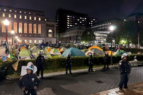 In this photo released by the New York City Police Department, New York Police officers surround the south lawn as protesters are cleared from Hamilton Hall and the encampment, Tuesday, April 30, 2024, in New York