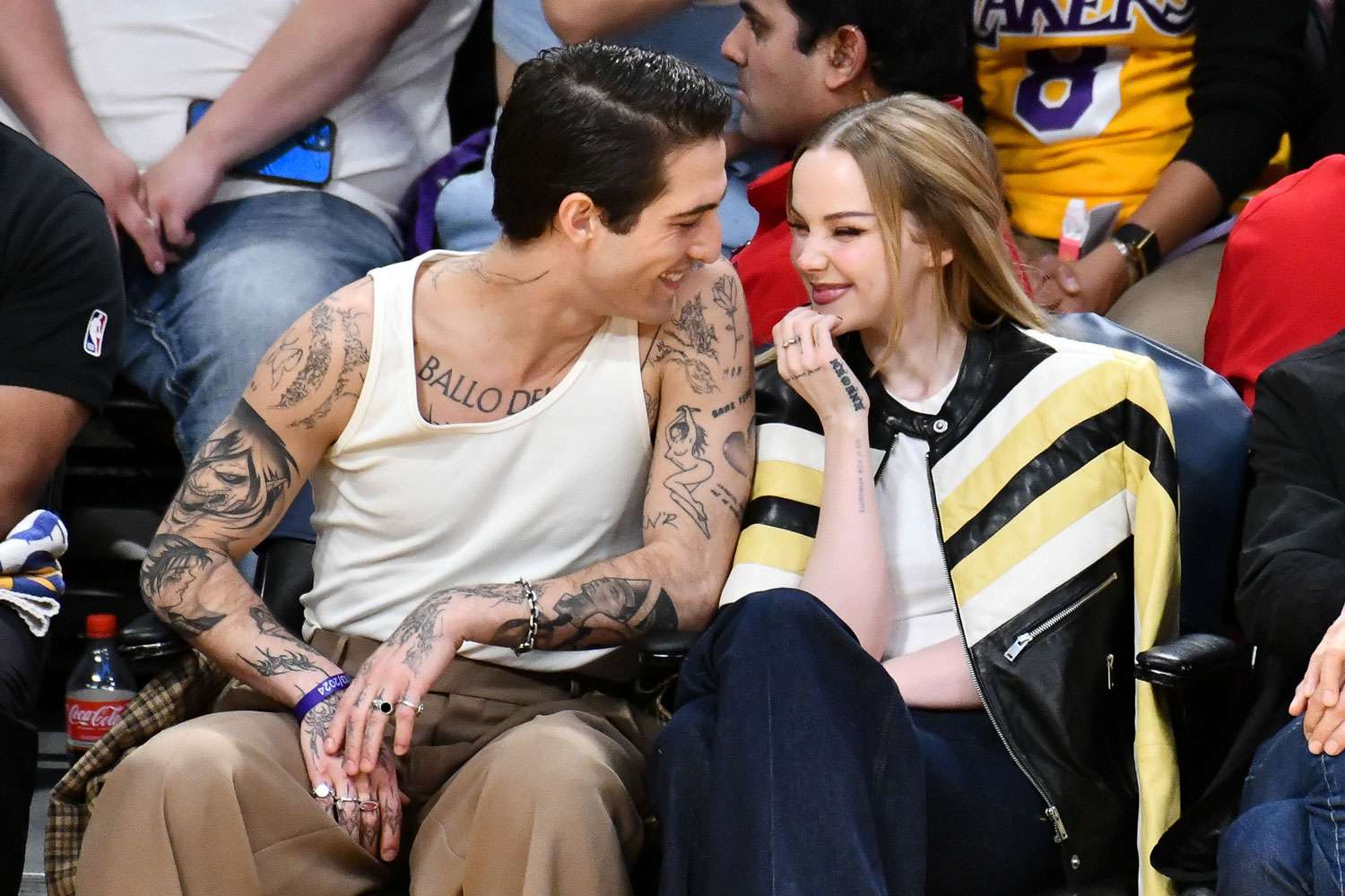 Damiano David (L) and Dove Cameron attend a basketball game between the Los Angeles Lakers and the Detroit Pistons at Crypto.com Arena on February 13, 2024 in Los Angeles, California